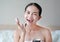 Beauty asian woman applying makeup with Sponge Powder Puff. woman make up herself