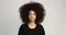 Beauty black woman with a huge afro hair having fun smiling and touching her hair