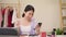 Beauty blogger question and answer by phone sitting in front tablet for recording video. Happy beautiful young Asian woman use