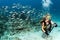 Beauty blonde diver taking a selfie underwater