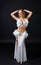 Beauty blonde in white belly dancer costume .