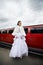 Beauty bride on background red limo car