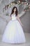 Beauty bride in bridal gown indoors