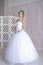 Beauty bride in bridal gown indoors