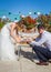 Beauty bride and handsome groom are cutting a wedding cake. Coup