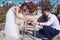 Beauty bride and handsome groom are cutting a wedding cake. Coup