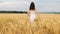 Beauty brunette girl with healthy long hair spinning and laughing outdoor on golden wheat field. Enjoying nature. Young