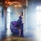 Beauty Brunette model woman in evening purple dress. Beautiful fashion luxury makeup and hairstyle