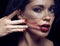 Beauty brunette woman under black veil with red manicure close up, grieving widow, halloween makeup luxury