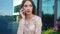 Beauty business lady sits in the street and talking by phone
