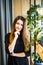 Beauty businesswoman standing with crossed arms in a bright office looking at the camera