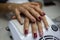 Beauty care. Close up detail of client hands recently hand painted by a worker. Professional manicure salon