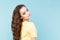 Beauty casual fasion portrait. Curly hair nice woman posing isolated over the blue background.