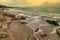 Beauty cloudy, long exposure seascape with waves flowing between rocks