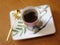 Beauty coffeecup standing on wooden table with dark tasty coffee