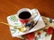 Beauty coffeecup standing on wooden table with dark tasty coffee