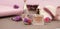 Beauty and Cosmetic Concept. Perfume bottles, cosmetcis, powder and brushes. Pink Background. Copy space. Banner.