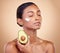 Beauty, cream and skincare with woman and avocado in studio for product, fruit and natural cosmetics. Spa, facial and