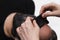 Beauty doctor removes skin alginate seaweed black mask from male patient face