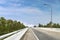 Beauty empty highway road with lamp post and tree on blue sky day background