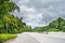 Beauty empty highway road with lamp post and tree on cloudy sky background