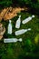 Beauty face, hair, medical ampoule sample containers cosmetic on grass. Top view. Anti Aging serum skin care.