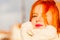 Beauty face redhaired woman in warm clothing outdoor