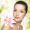 Beauty face of young woman with flower. Beauty treatment concept