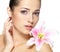 Beauty face of young woman with flower. Beauty treatment concept