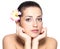 Beauty face of young woman with flower. Beauty treatment concept