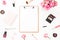 Beauty or fashion blog composition with pink roses bouquet, cosmetics, diary and clipboard on white background. Top view. Flat lay