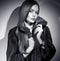 Beauty Fashion Model Girl in Mink Fur Coat black and white portrait. Beautiful Woman in Luxury Brown Fur Jacket posing in studio