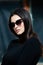 Beauty fashion portrait of young beautiful brunette girl with long black hair wearing sunglasses.