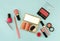 Beauty flat lay with woman make up products and accessories in pink colour