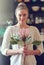 The beauty of fynbos. Portrait of a beautiful young woman standing in her kitchen holding a protea flower.