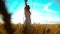 Beauty girl outdoors enjoying nature wheat field slow motion video. Beautiful girl in white dress running nature freedom