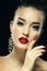 Beauty Girl with Red Lips and Nails. Luxury Woman, jewelery earrings.