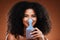 Beauty, hair care and portrait of black woman with comb for afro, natural and curly hair on brown background. Hair salon