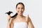 Beauty, hair loss products, shampoo and hair care concept. Close-up of satisfied, happy asian girl in bath towel showing