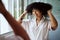 Beauty, hair and mirror with a black woman in the bathroom of her home for a morning haircare routine. Growth, wellness