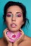 Beauty image of woman with beautiful skin and high quality make up featuring cyan and pink colours