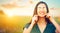 Beauty joyful girl with daisy flowers on her eyes enjoying nature and laughing on summer field