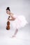 The beauty lady is wearing pink ballet dress, stand and bend body down,hold violin in hand,with smile and happy face,