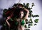 The beauty lady wrapped body with green leaf and flower,beside violin and bow,posing like jungle,sign and symbol of Nature conserv