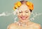 Beauty laughing girl with splashes of water and yellow flowers