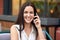 Beauty, leisure and positive emotions concept. Happy brunette young woman with toothy smile, dressed in white summer blouse, poses