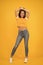 Beauty and make up. Skinny jeans suits her. Self confidence is best outfit. Sexy girl yellow background. Sexi girl