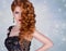 Beauty model with a bright evening make-up.Jewellery.luxurious glamorous redhead girl with curly.