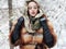 Beauty model girl in winter forest. beautiful young Woman in fashionable Fur Coat and scarf