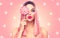 Beauty model woman with trendy pink hairstyle and beautiful makeup holding lollipop candy